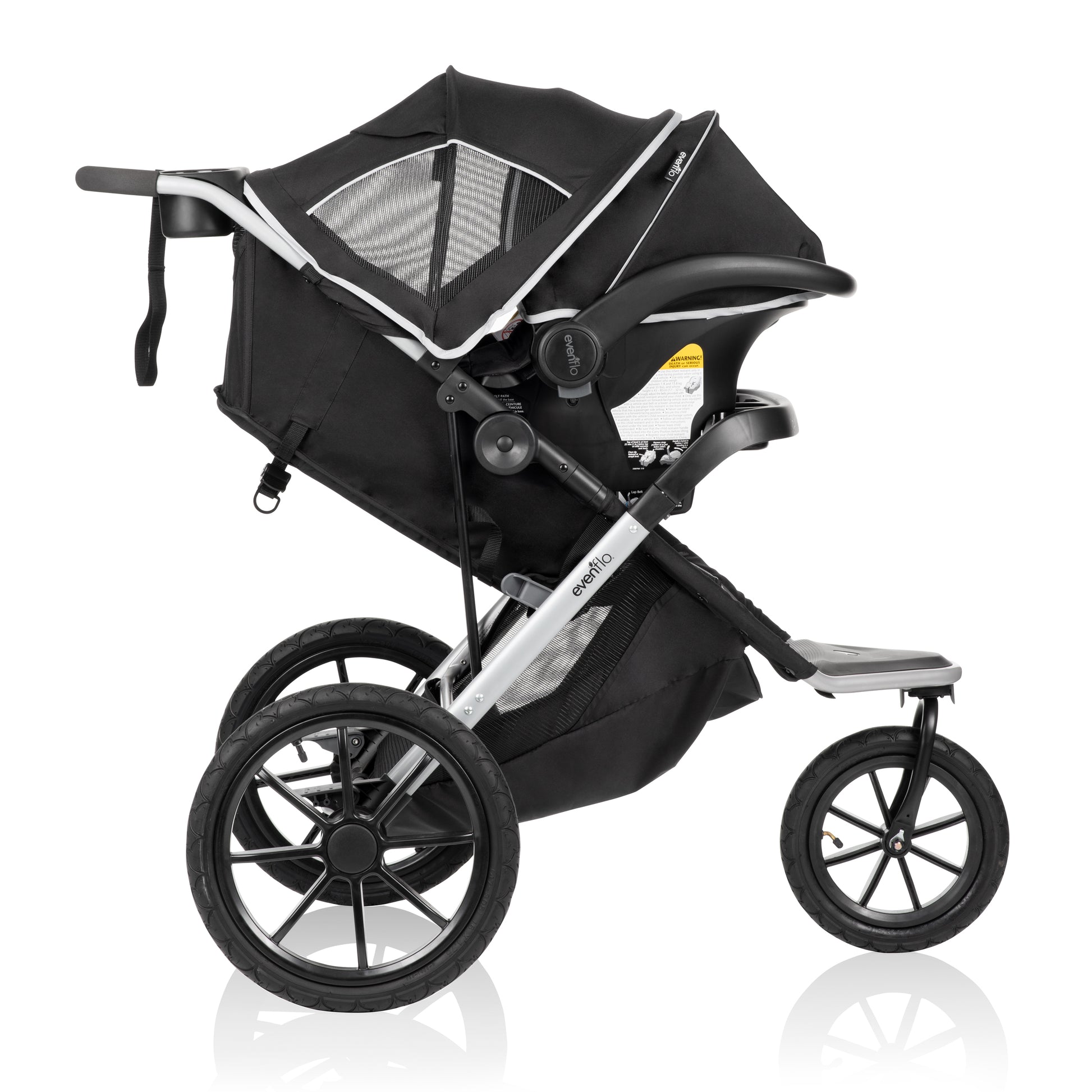 Side view of a black Evenflo jogging stroller with a car seat attached, featuring large all-terrain wheels.