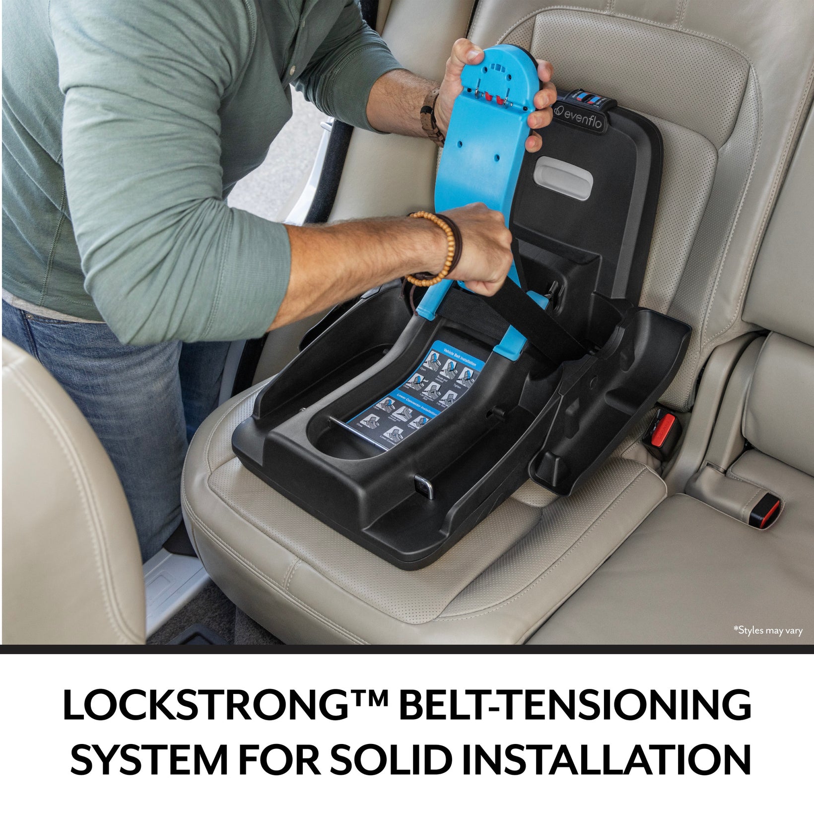 A man uses a blue tensioning device to install a black Evenflo car seat base in a vehicle.