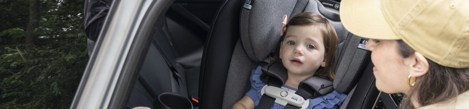 You look lovingly at your curious child, who is safe and secure in their car seat.