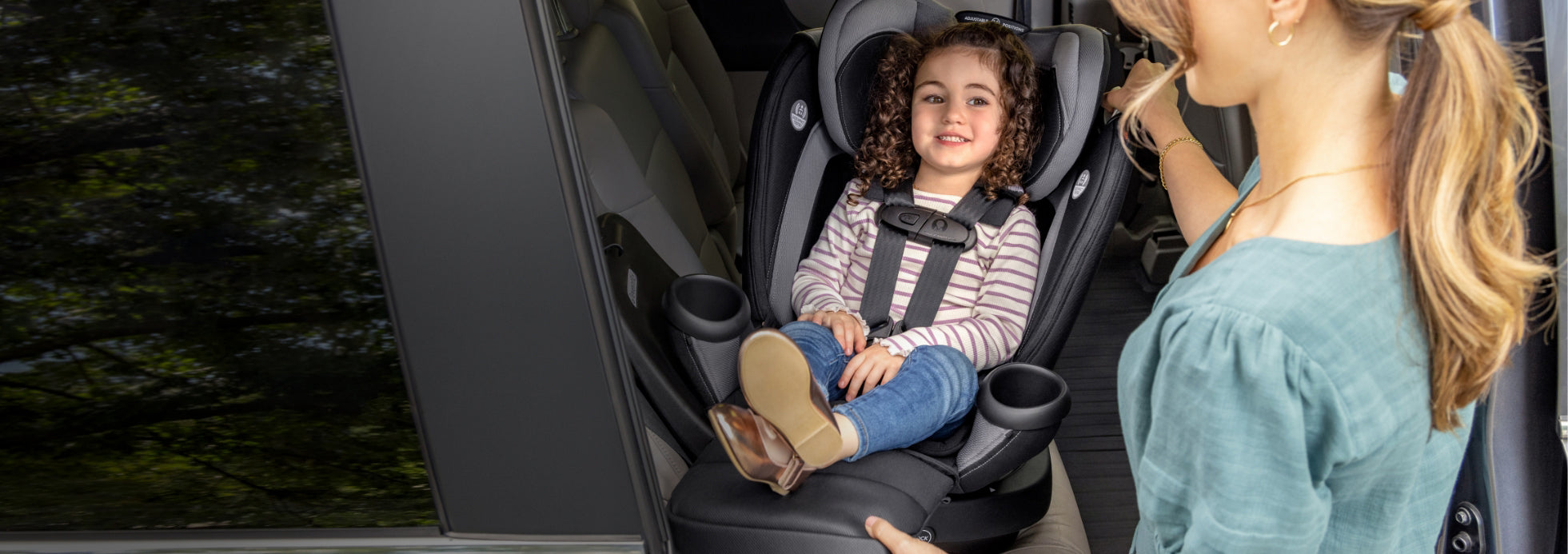 Secure your smiling child safely and comfortably in a car seat with convenient cup holders.