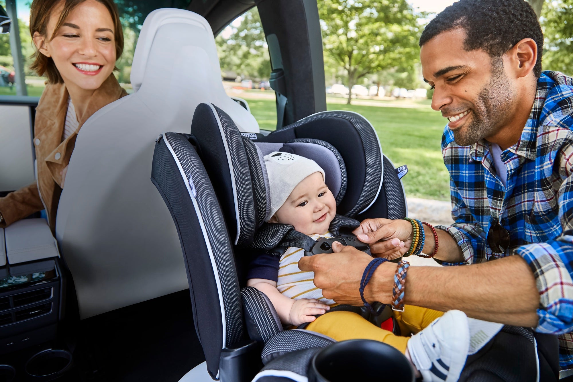 See how your baby is happy and safe as you and your partner buckle them in.