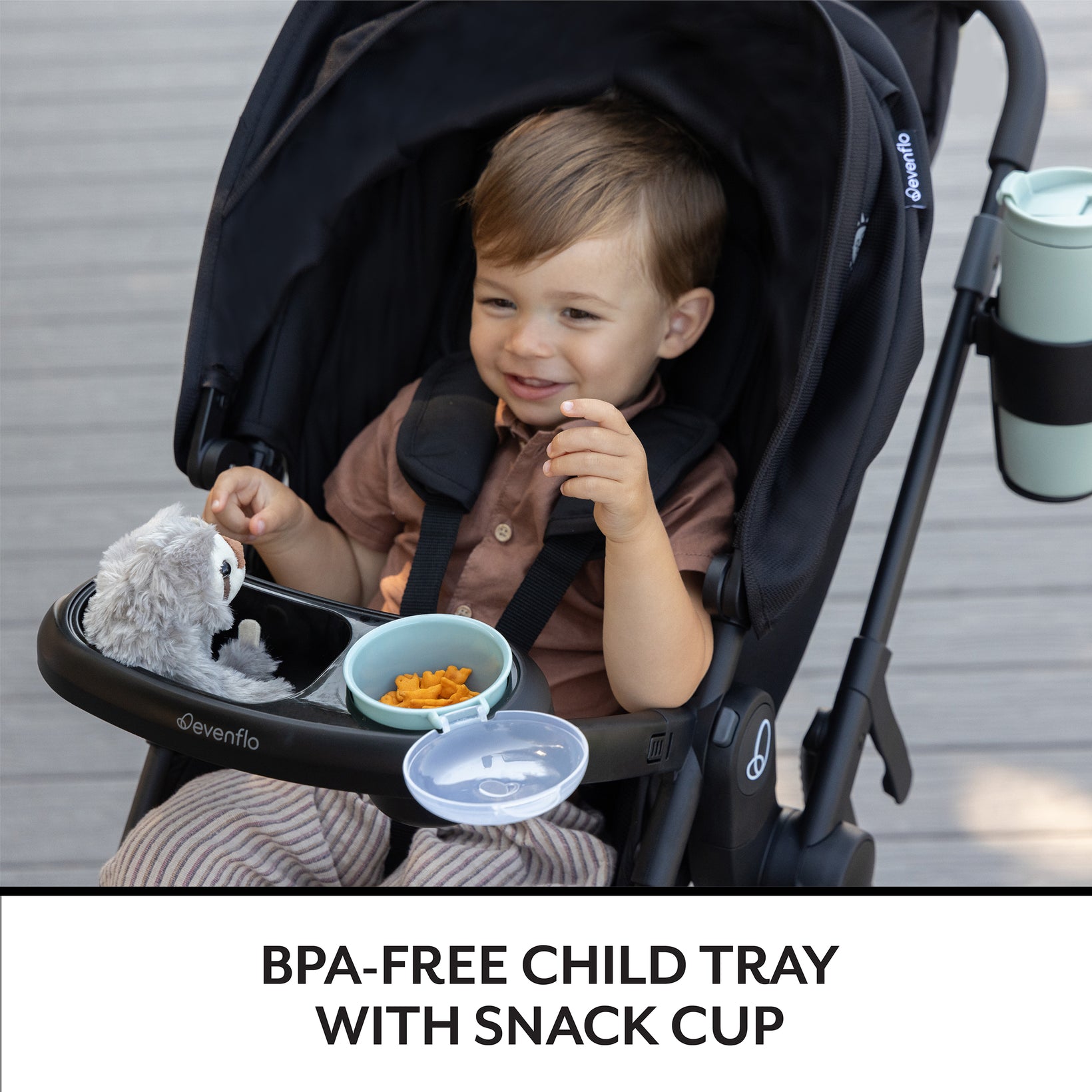 Child in a stroller with a BPA-free child tray and snack cup, featuring the brand 'Ovation'.
