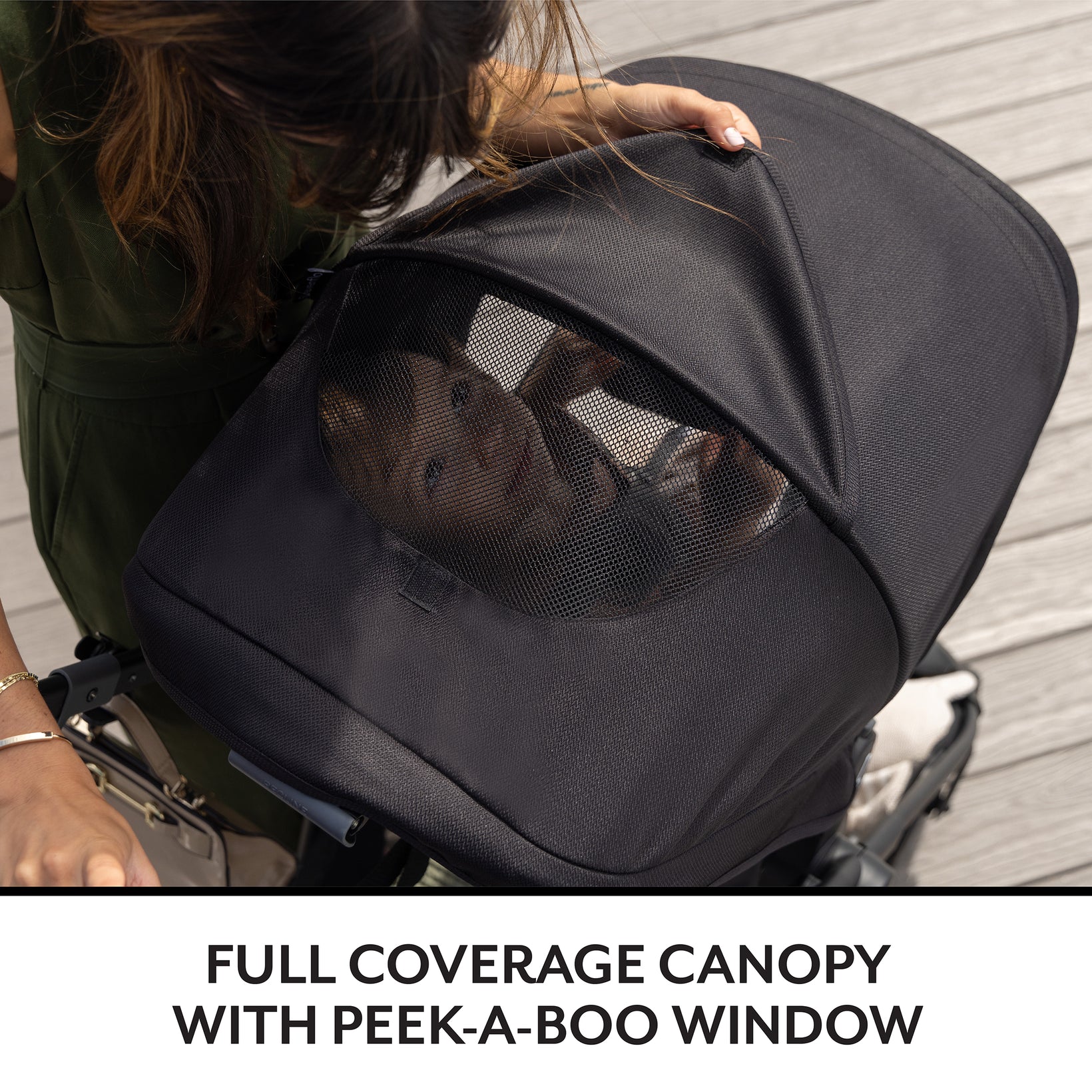 Baby inside a stroller with a peek-a-boo window