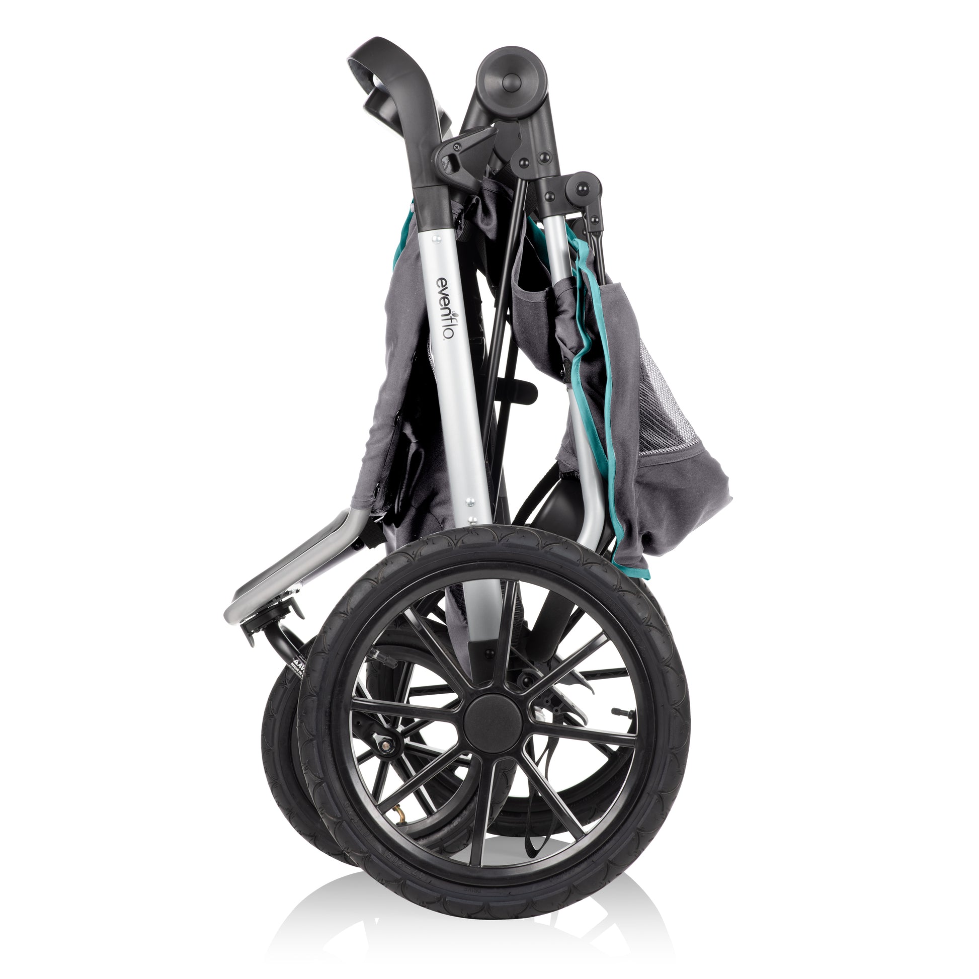 An Evenflo jogging stroller folded for compact storage, with its large wheels still visible.