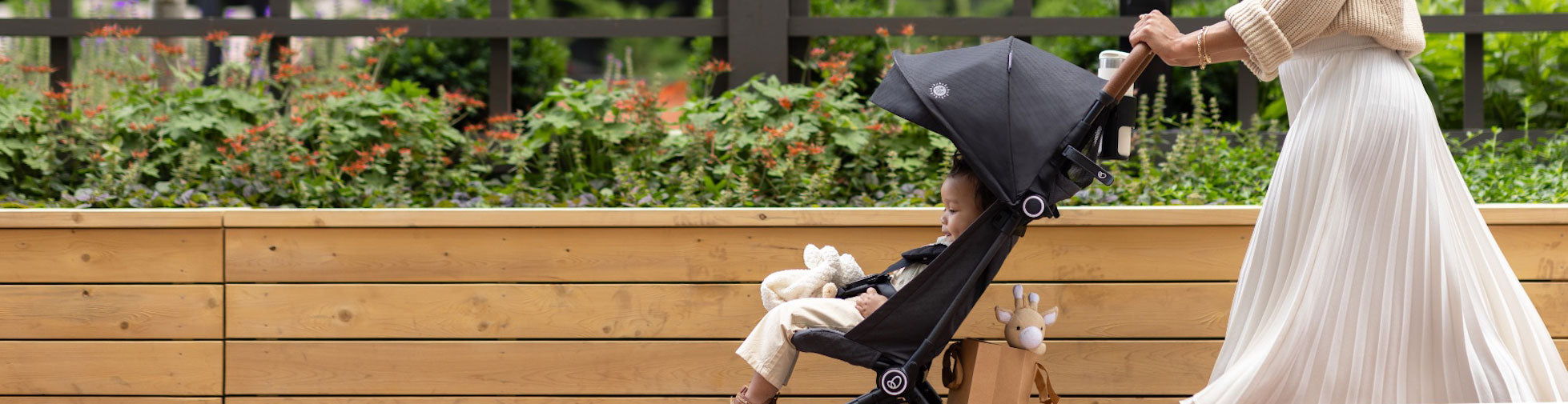 Enjoy a leisurely walk as you push your content child in a sleek, comfortable stroller.