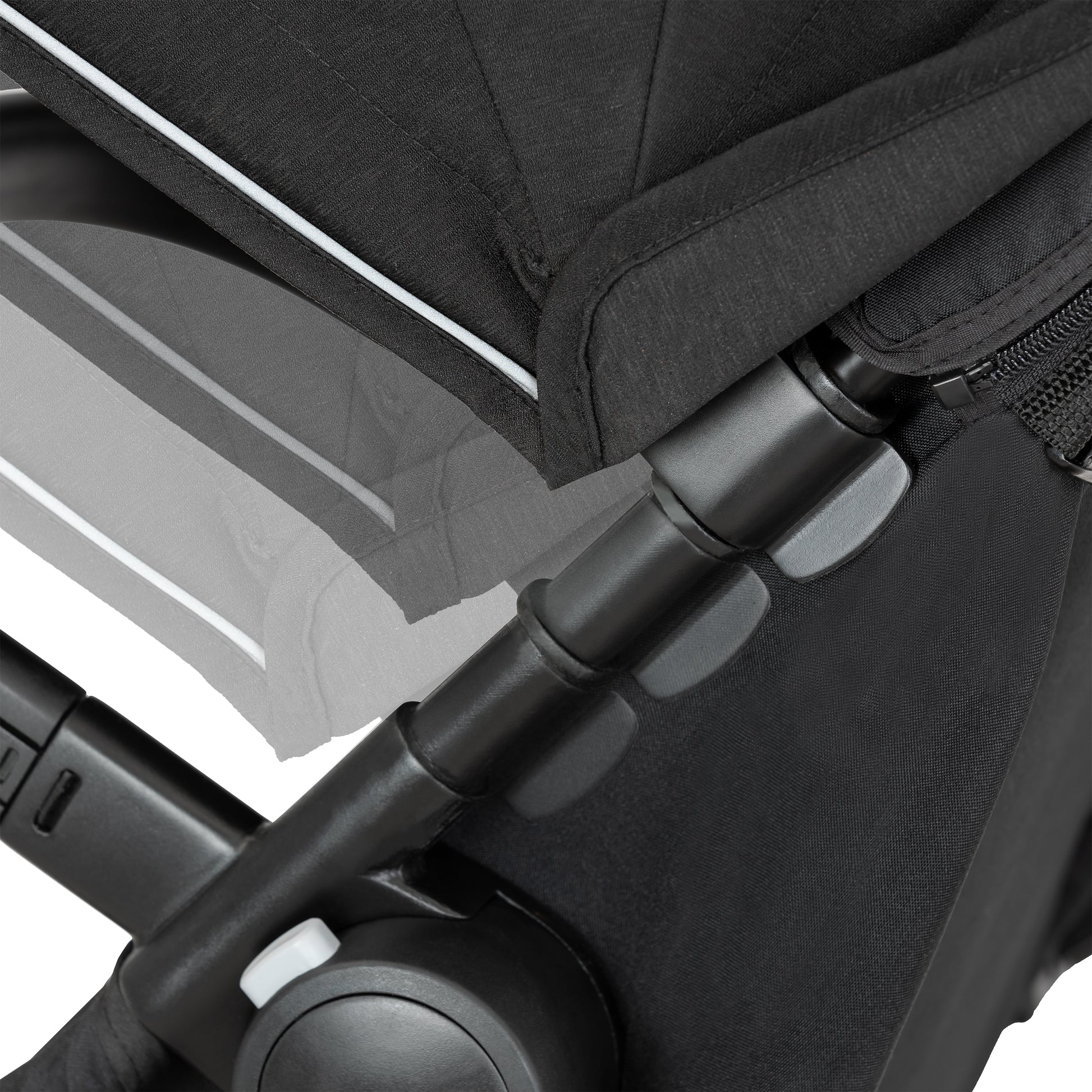 Close-up of a black stroller with a focus on the handle and seat area.