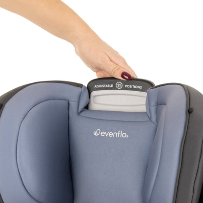 Evenflo car seat with adjustable headrest and hand interacting with it on a white background