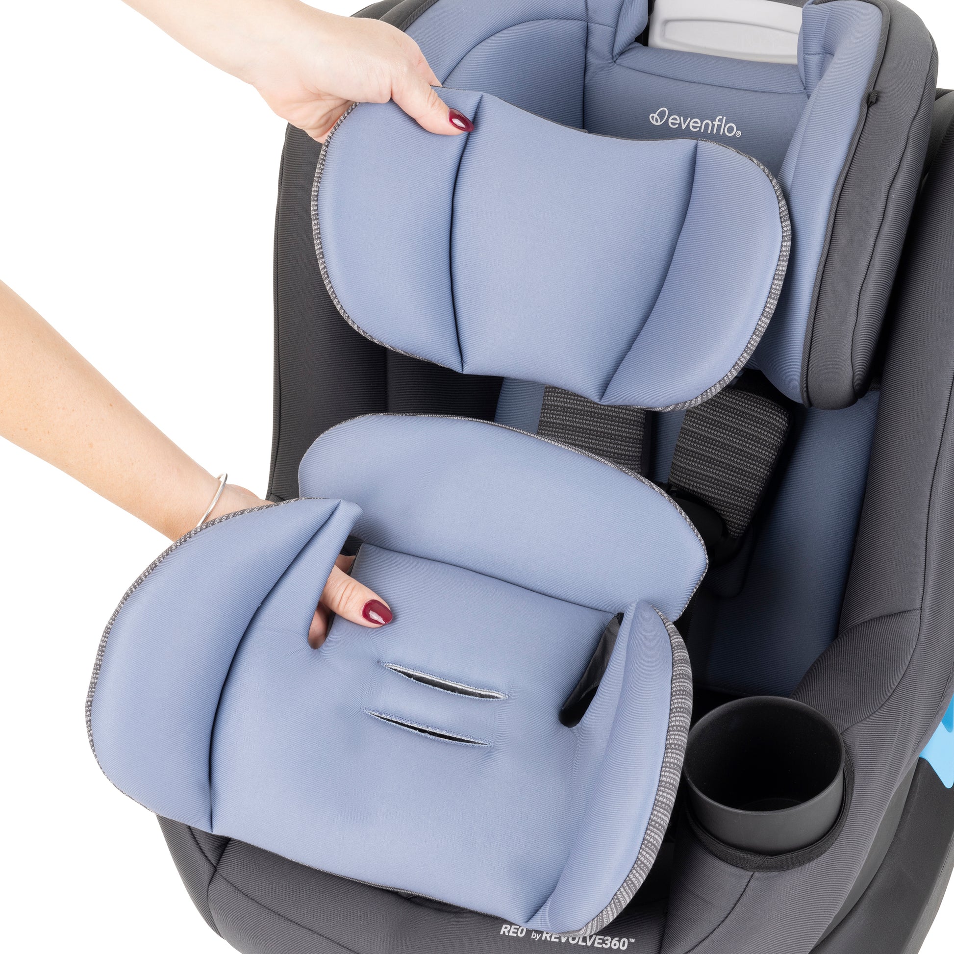 Baby car seat with blue padding being adjusted