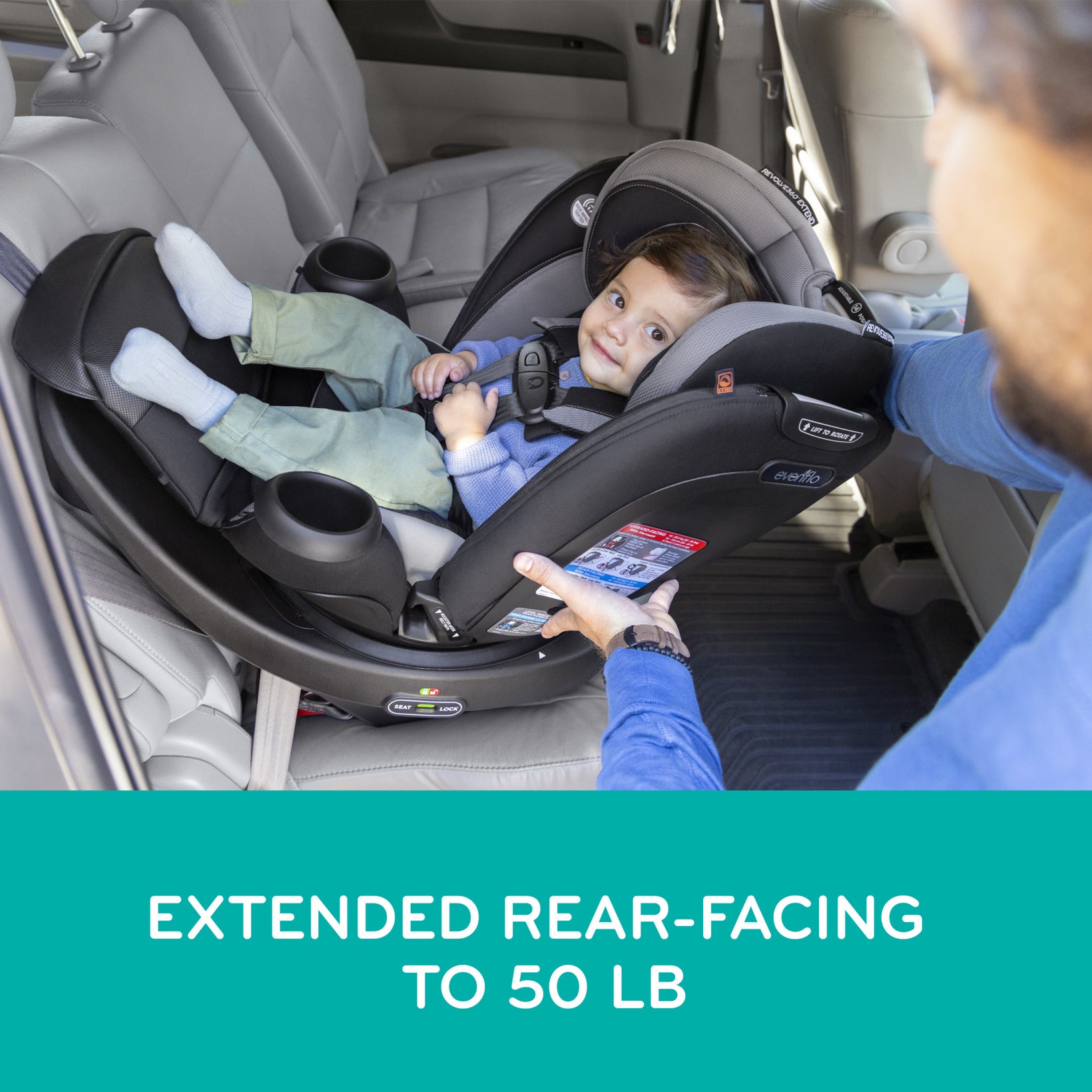 Child in a car seat with an adult adjusting it, inside a vehicle. 
