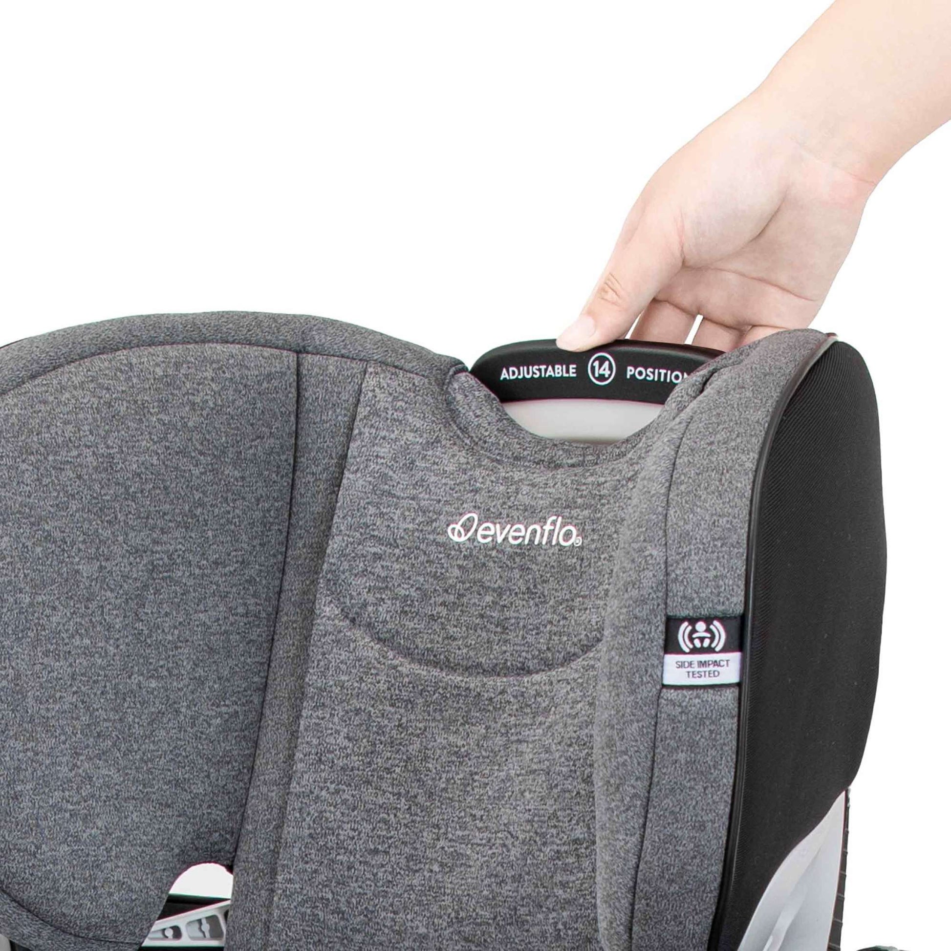 Hand adjusting the 14-position headrest on a gray Evenflo car seat.
