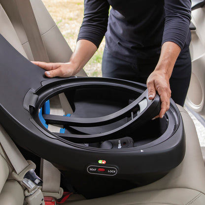 Person opening the base of an Evenflo Revolve360 Extend car seat to install it.