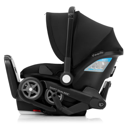 Side view of a black Evenflo Shyft DualRide infant car seat with the integrated stroller wheels folded.