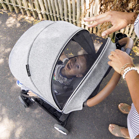 Keep an eye on your baby easily with this stroller's convenient peek-a-boo window.