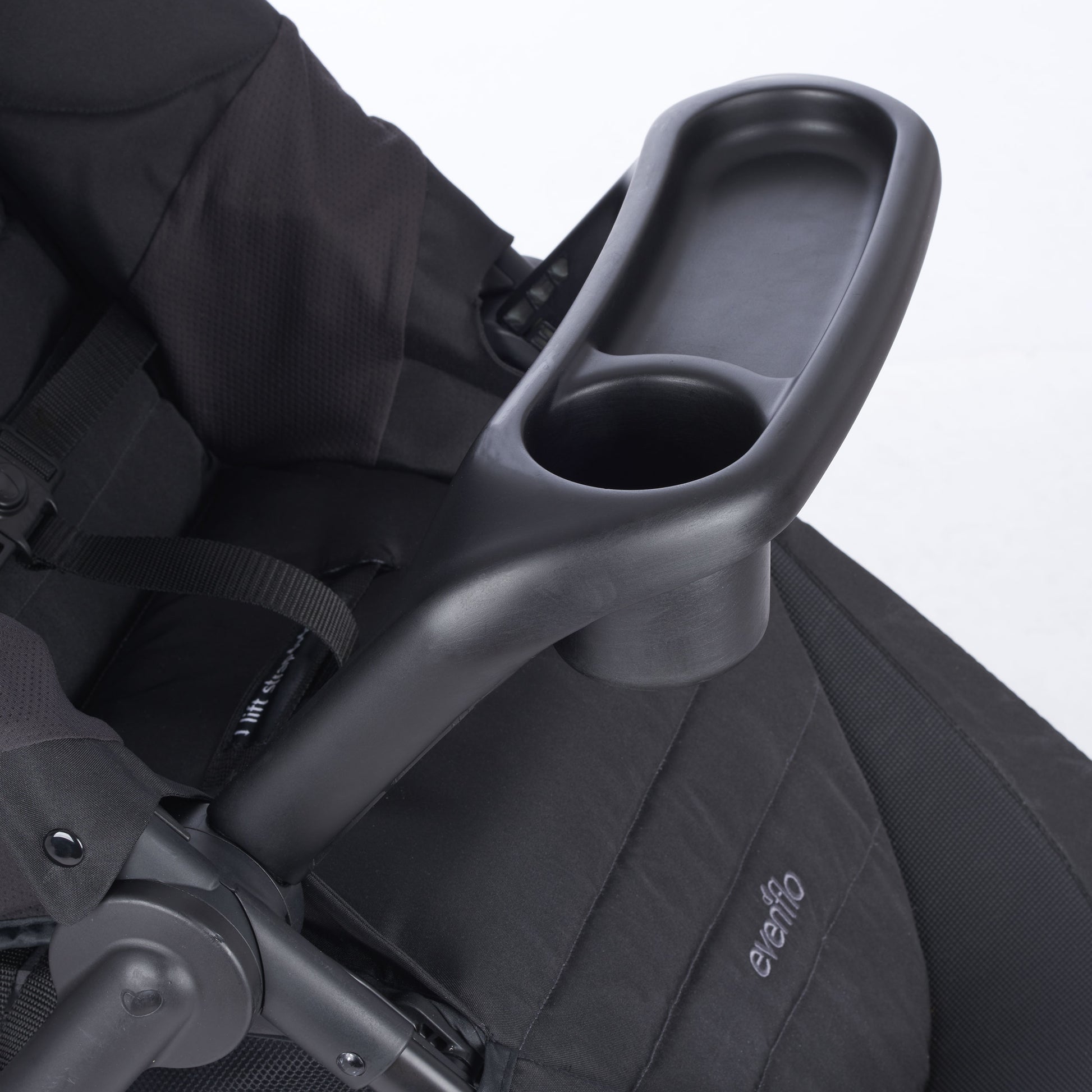 Black cup holder attached to a black stroller seat 