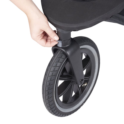 Manually adjusting a stroller wheel on a white background